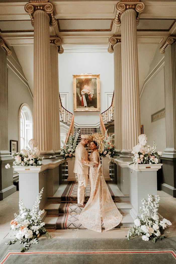 bride and groom at signet library in edinburgh with indonesian wedding outfits