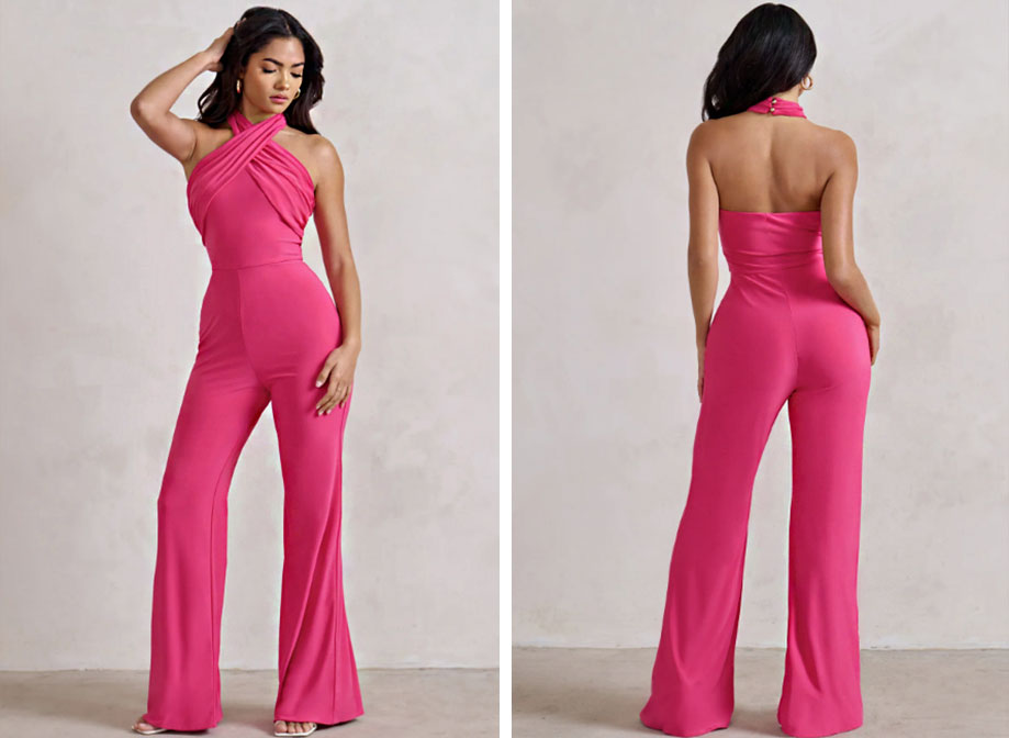 A woman wearing a pink fitted jumpsuit with flared legs and a halter top