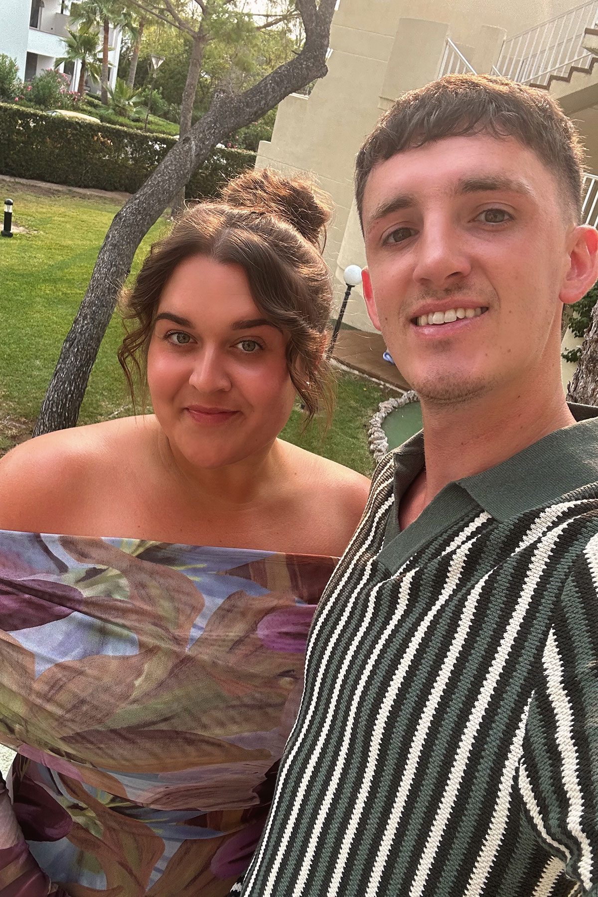 Bride-to-be and fiancé smiling together outdoors on holiday