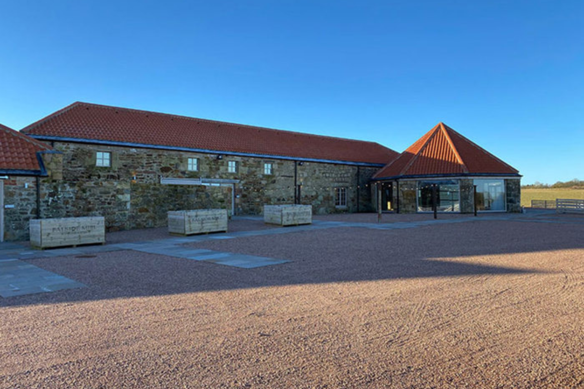 shot of barn next to blue sky