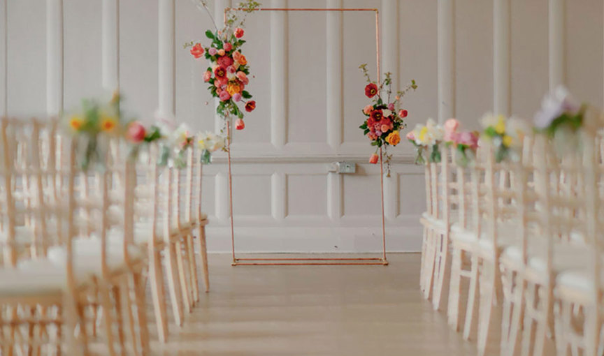 Summerhall set for a wedding ceremony with chairs and flowers