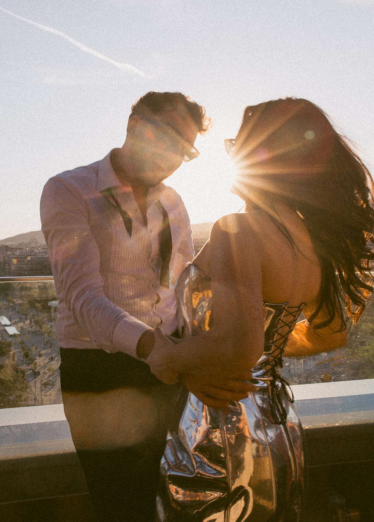 Newlyweds dance together at sunset overlooking Barcelona during their rooftop wedding after-party at The Hoxton.