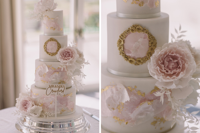 White wedding cake with pink and gold accents