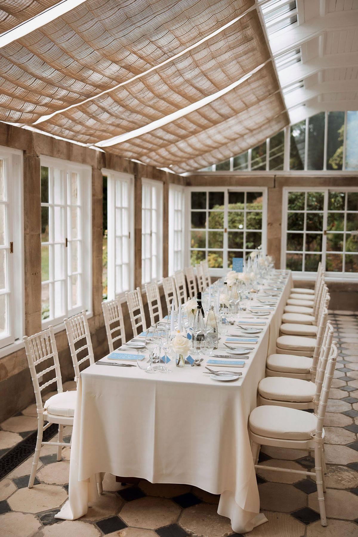Rosebery House orangery dining setup with long table and natural light for wedding reception