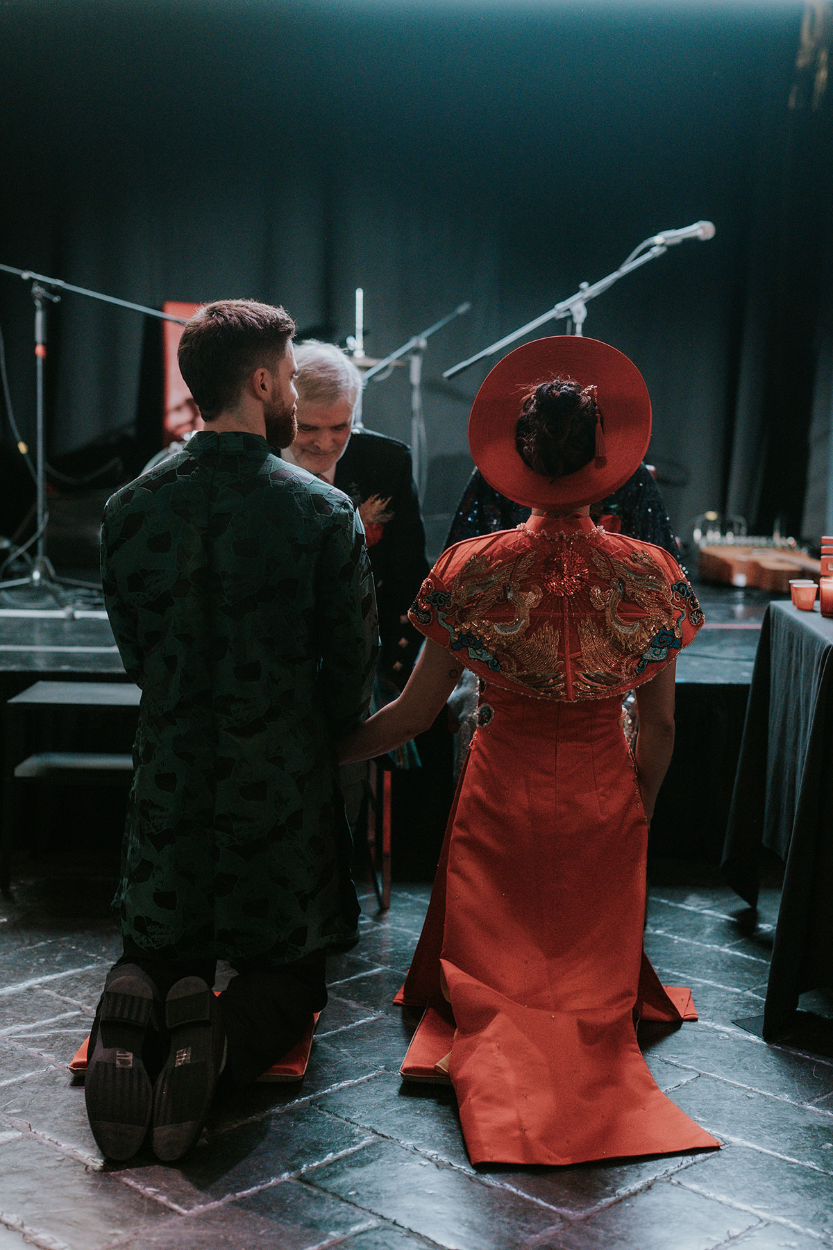 Bride and groom kneeling during Vietnamese tea ceremony at BAaD Glasgow wedding reception