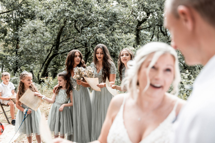 Bride in the foreground and bridesmaids in the background
