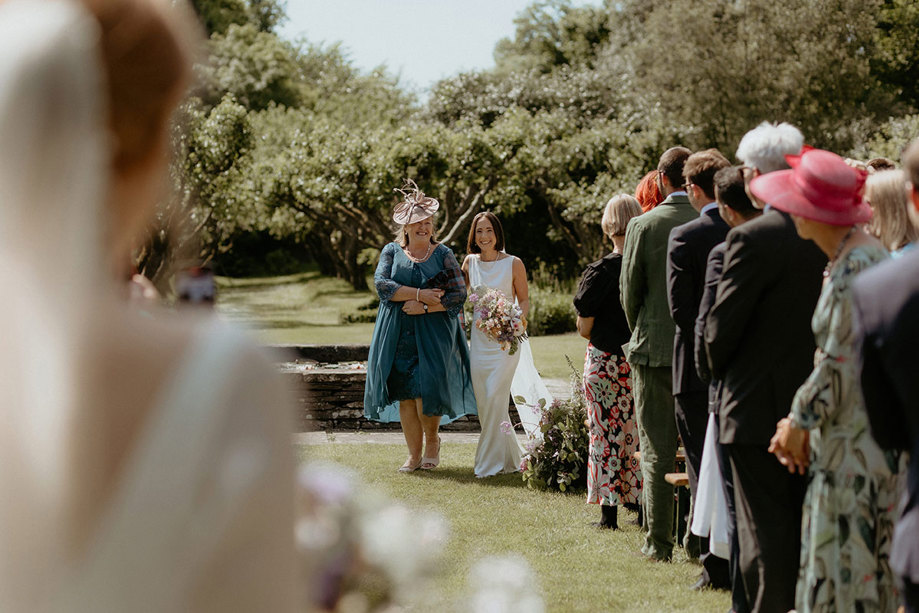 a bride and mum walking down outdoor aisle at the Byre at Inchrya 