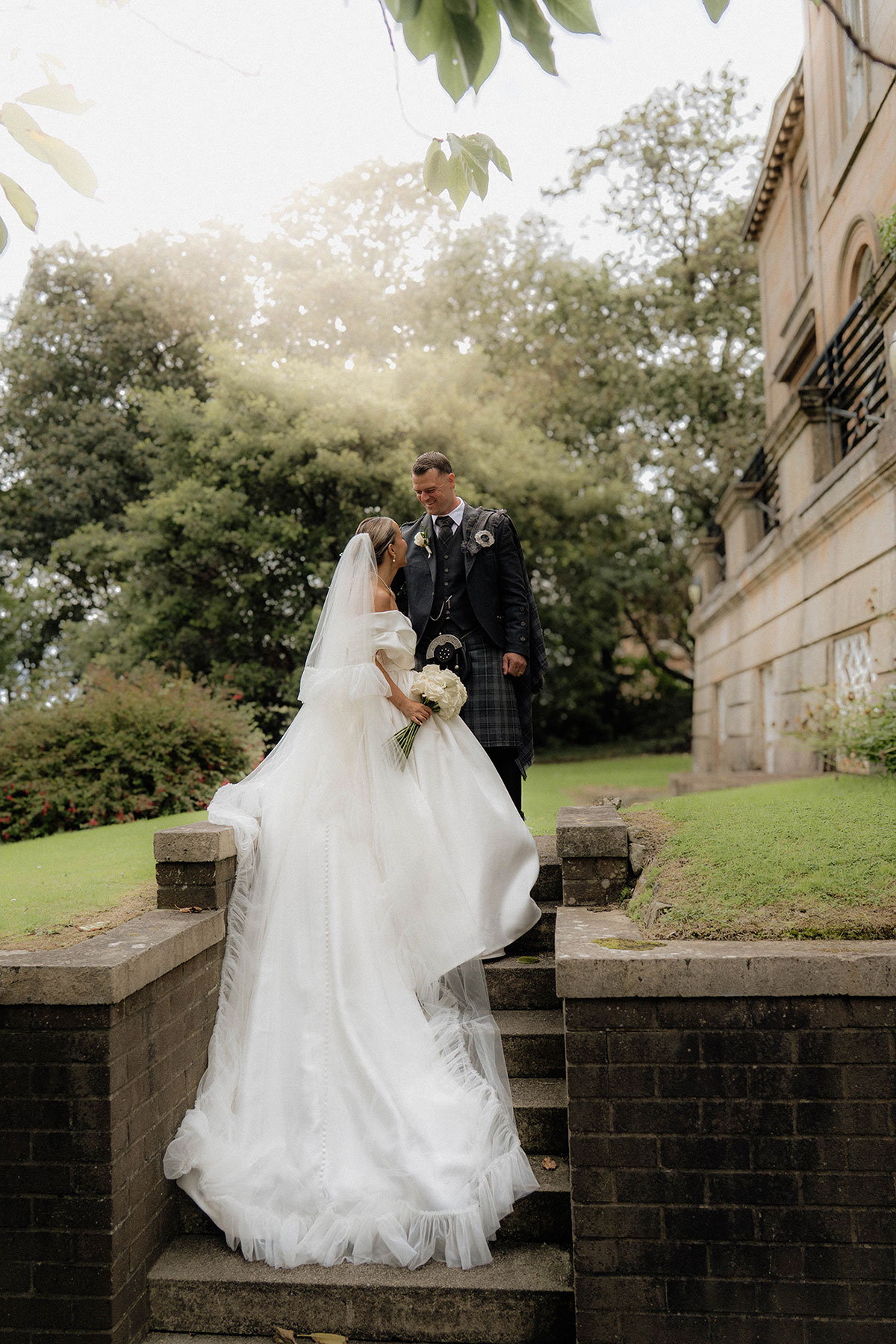 Bride and groom sharing a quiet moment in the gardens at Brisbane House Hotel during wedding portraits
