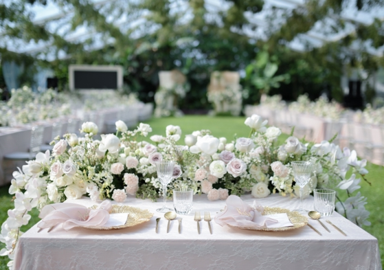 pastel wedding flowers are top table with place setting