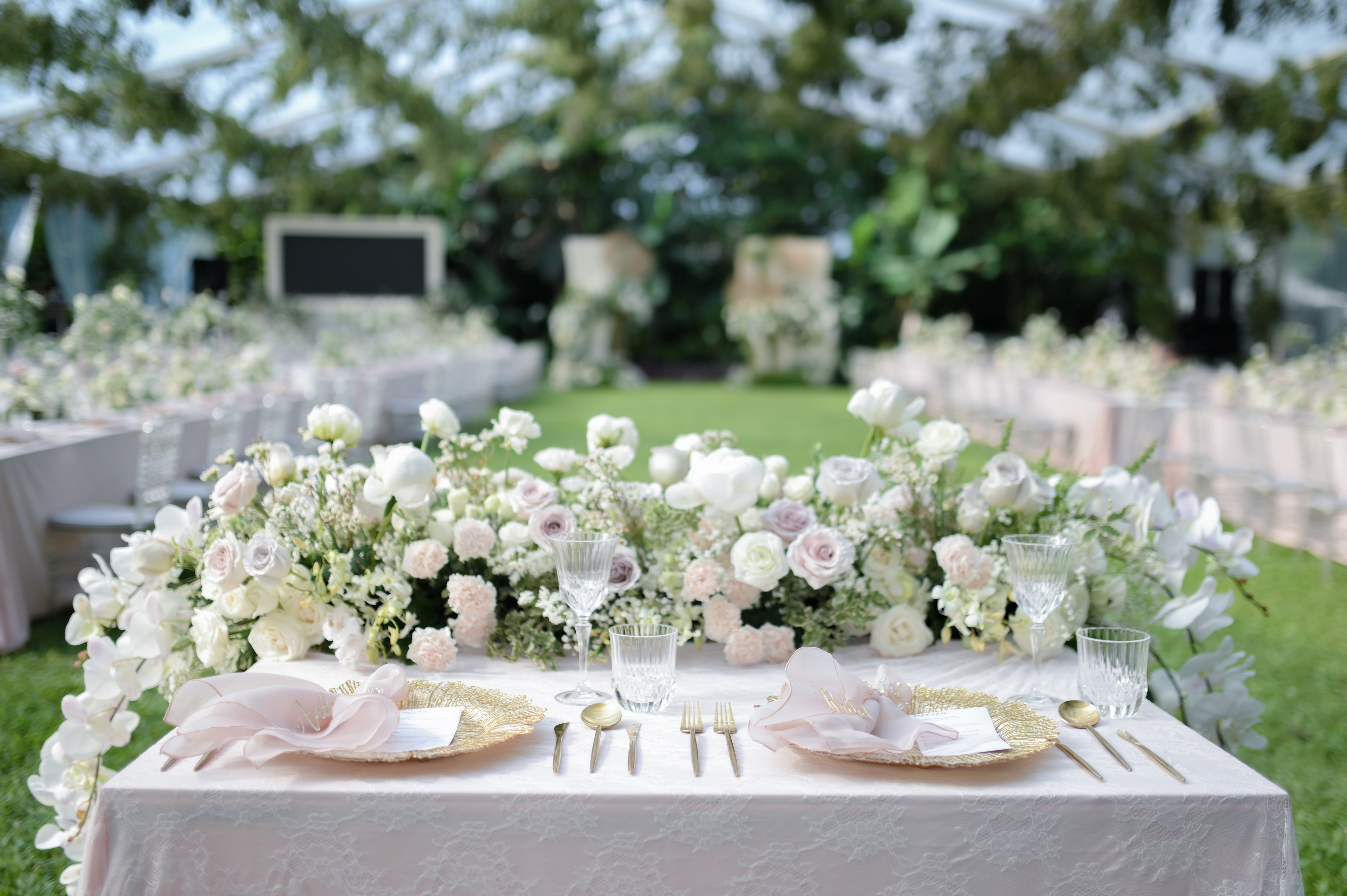 pastel wedding flowers are top table with place setting