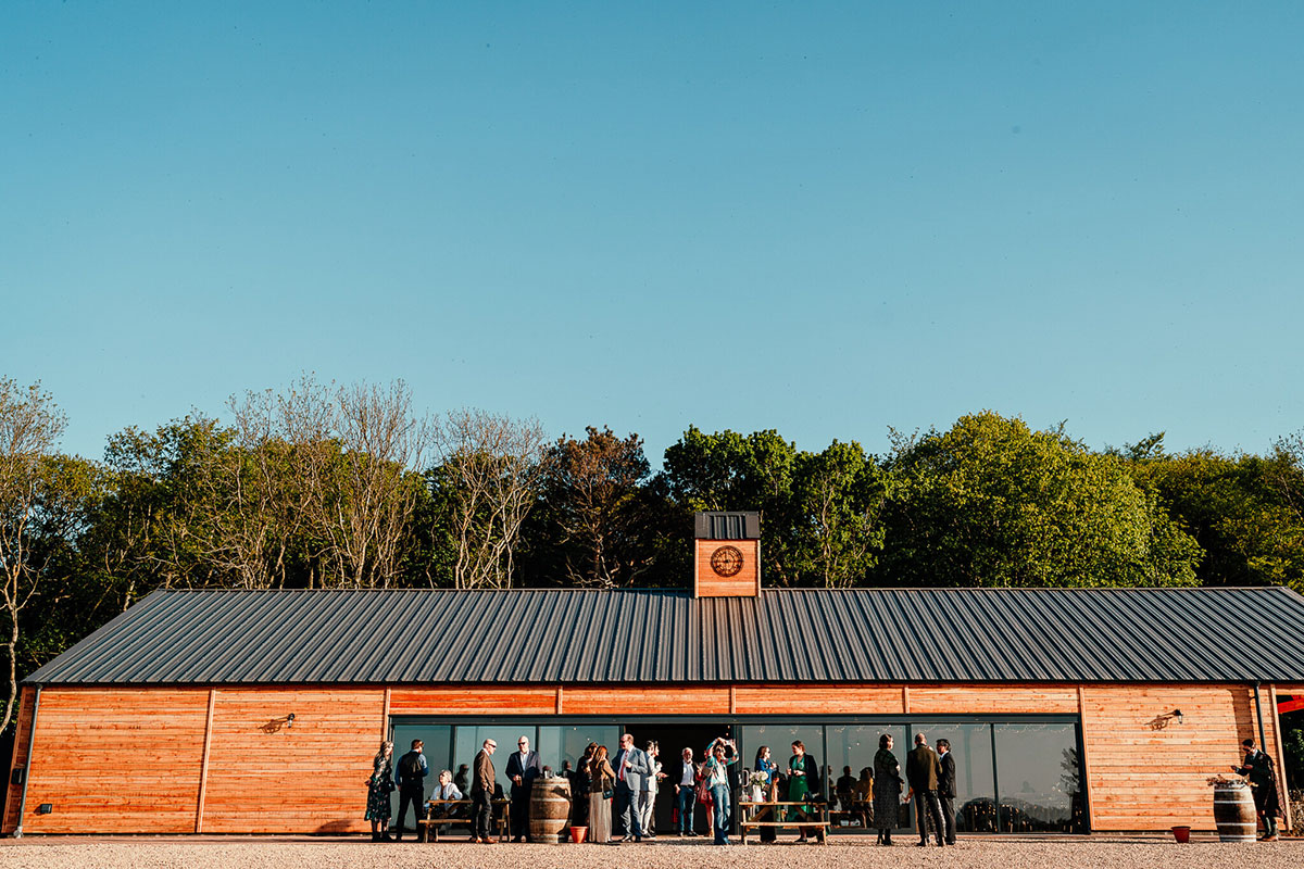 An exterior shot of Harvest Moon Weddings with guests gathered outside