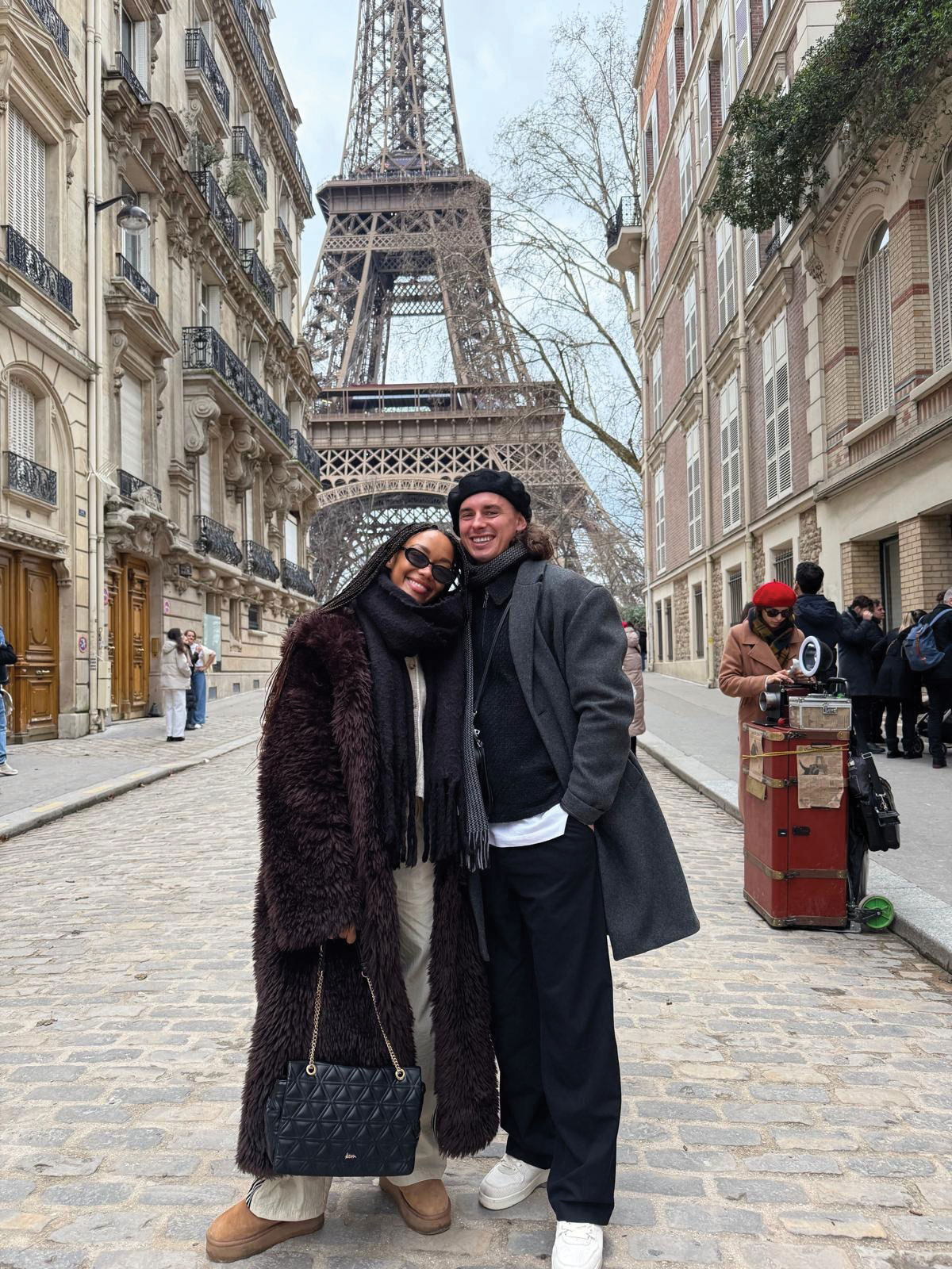 couple stand in front of eiffel tower in paris