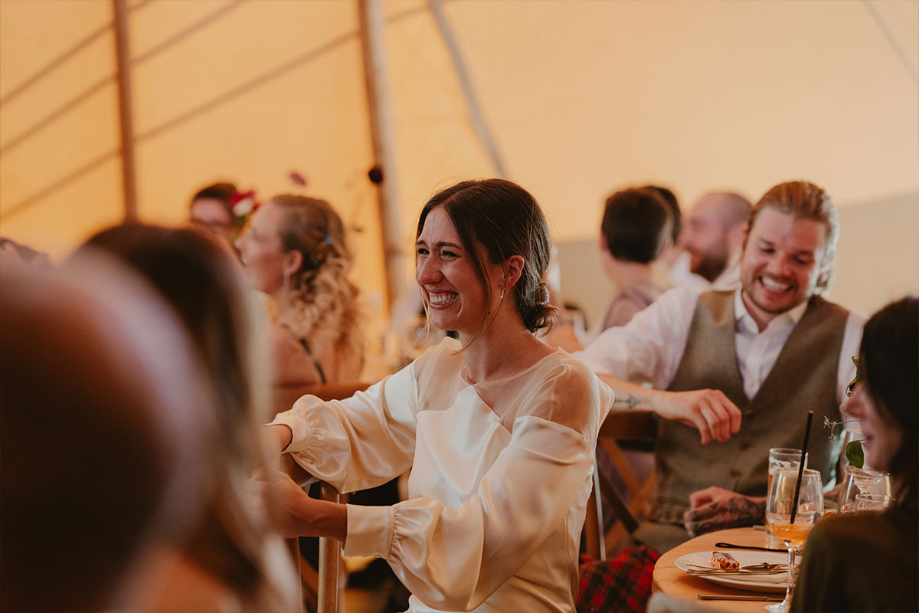 A Laughing Bride And Groom During Speeches In A Tipi