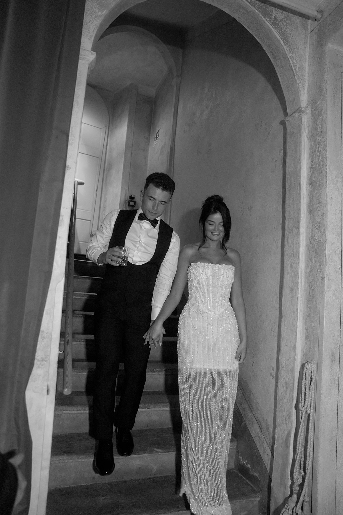 Bride and groom in evening wedding outfits during nighttime celebrations at Lake Como.