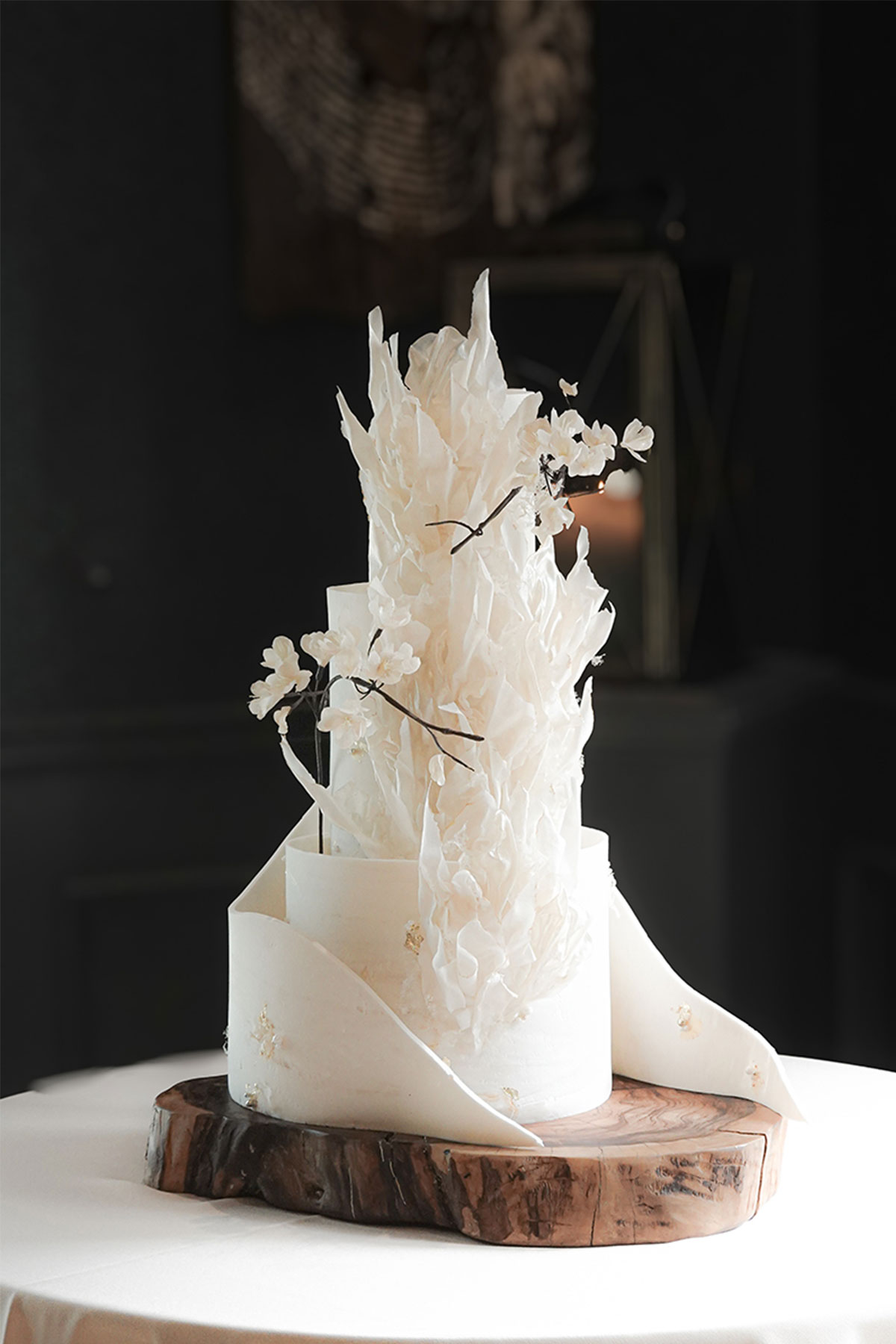  a three tier wedding cake with a 3D fondant white blossom design