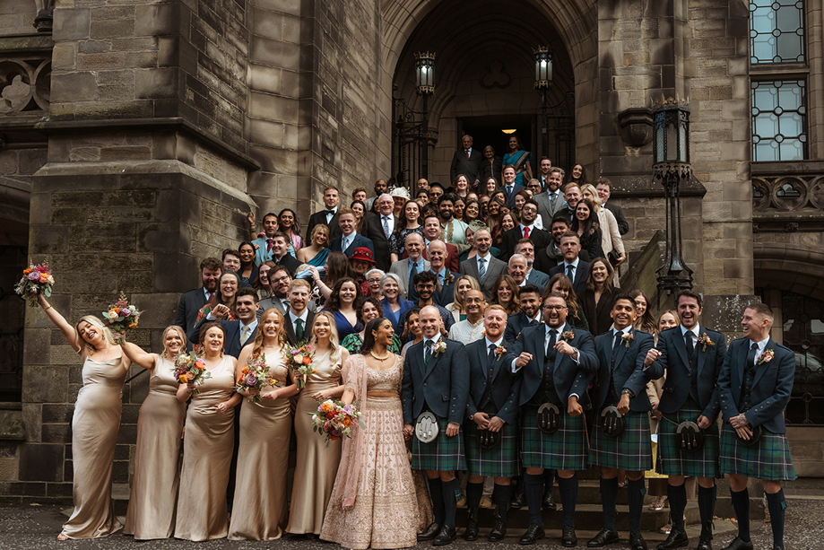 A Group Wedding Portrait On Stairs At Glasgow University