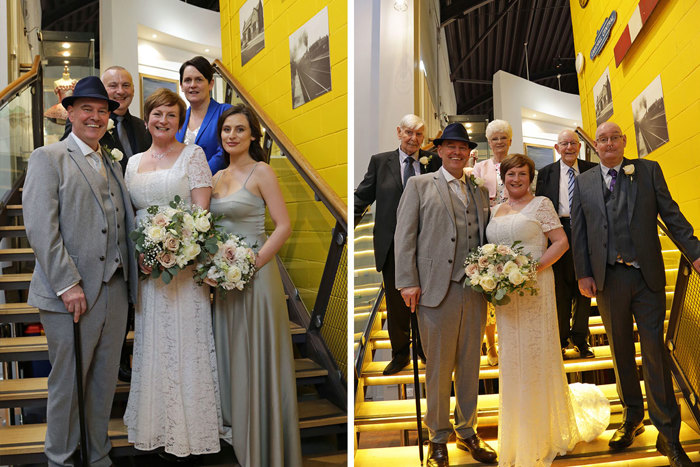 Two different groups of people stand on a staircase for a photo