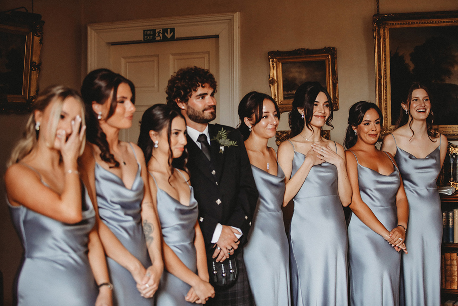 Bridesmaids Wearing Blue Satin Dresses With A Man In A Kilt