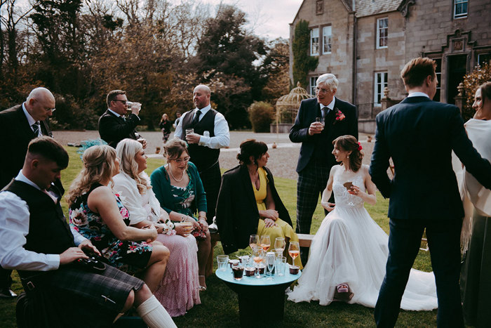 a group of people seated in the garden outside Netherbyres House