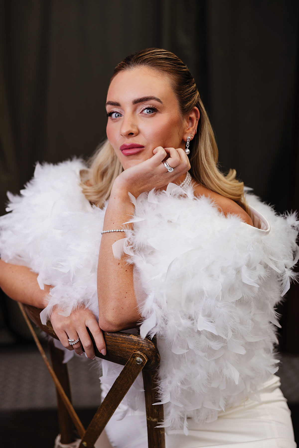 Bridal portrait with feather wrap, diamond jewellery and soft glam makeup at BAaD wedding shoot