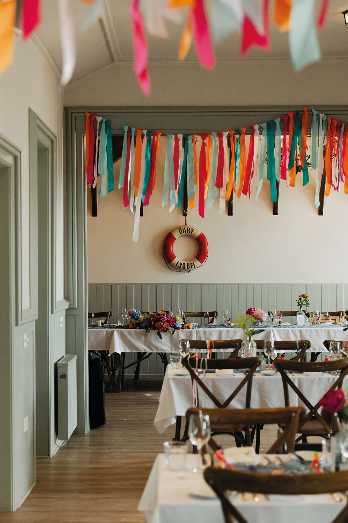Colourful wedding reception styling with ribbon bunting at Dougarie Boathouse on the Isle of Arran