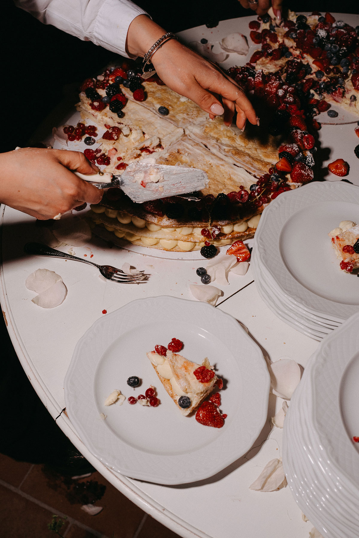 Millefoglie wedding cake being served with fresh berries at Antico Borgo San Lorenzo Tuscany