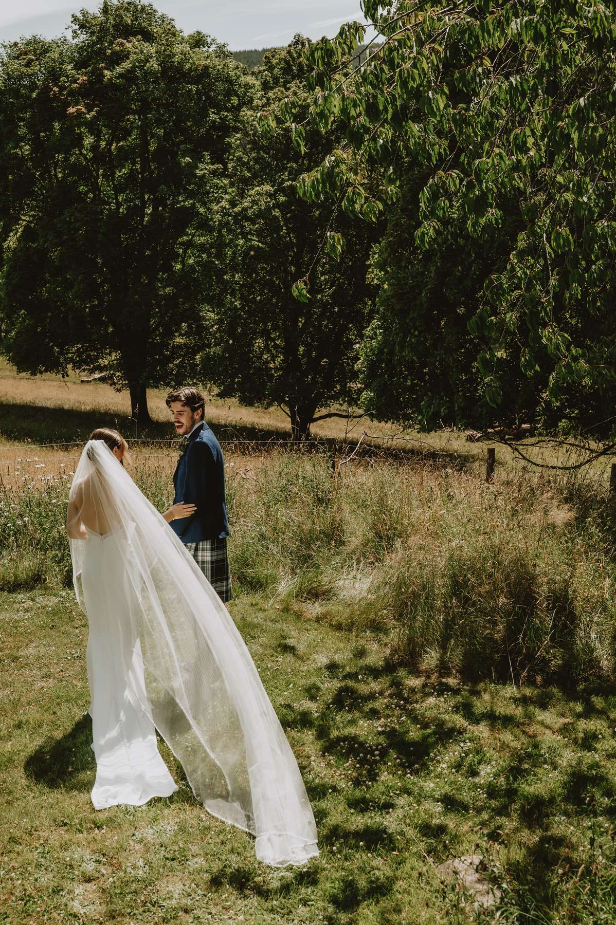 Bride and groom sharing a moment in the countryside grounds at Ballogie House