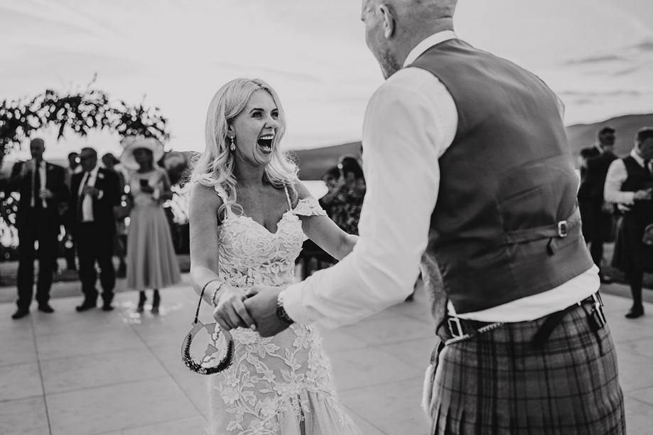 Black and white image of bride dancing