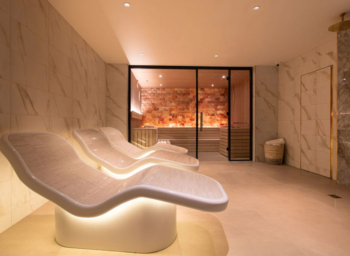 interior shot of wellness spa with heated loungers and sauna
