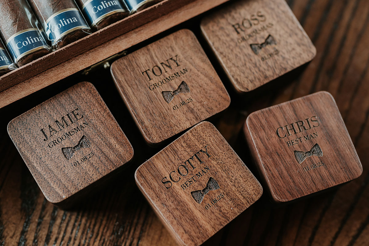 Personalised wooden groomsmen gift boxes with engraved names and wedding date