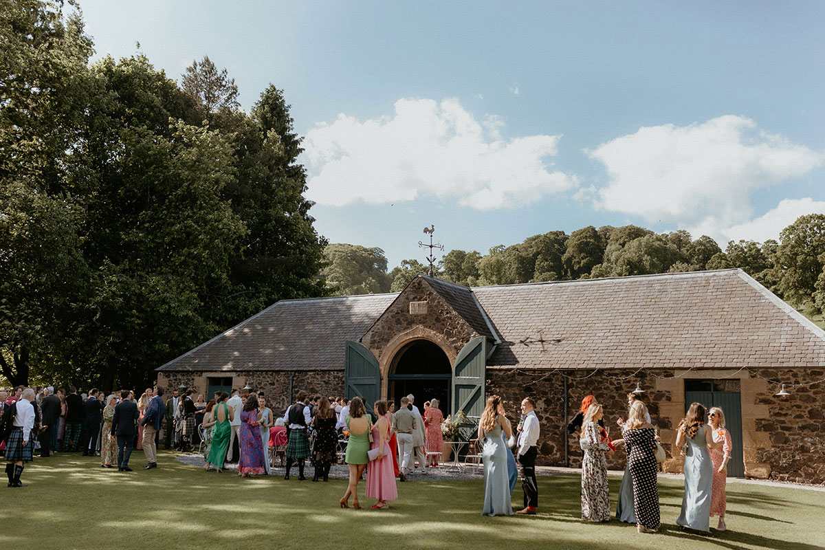 Guests standing outside the venue in the sun