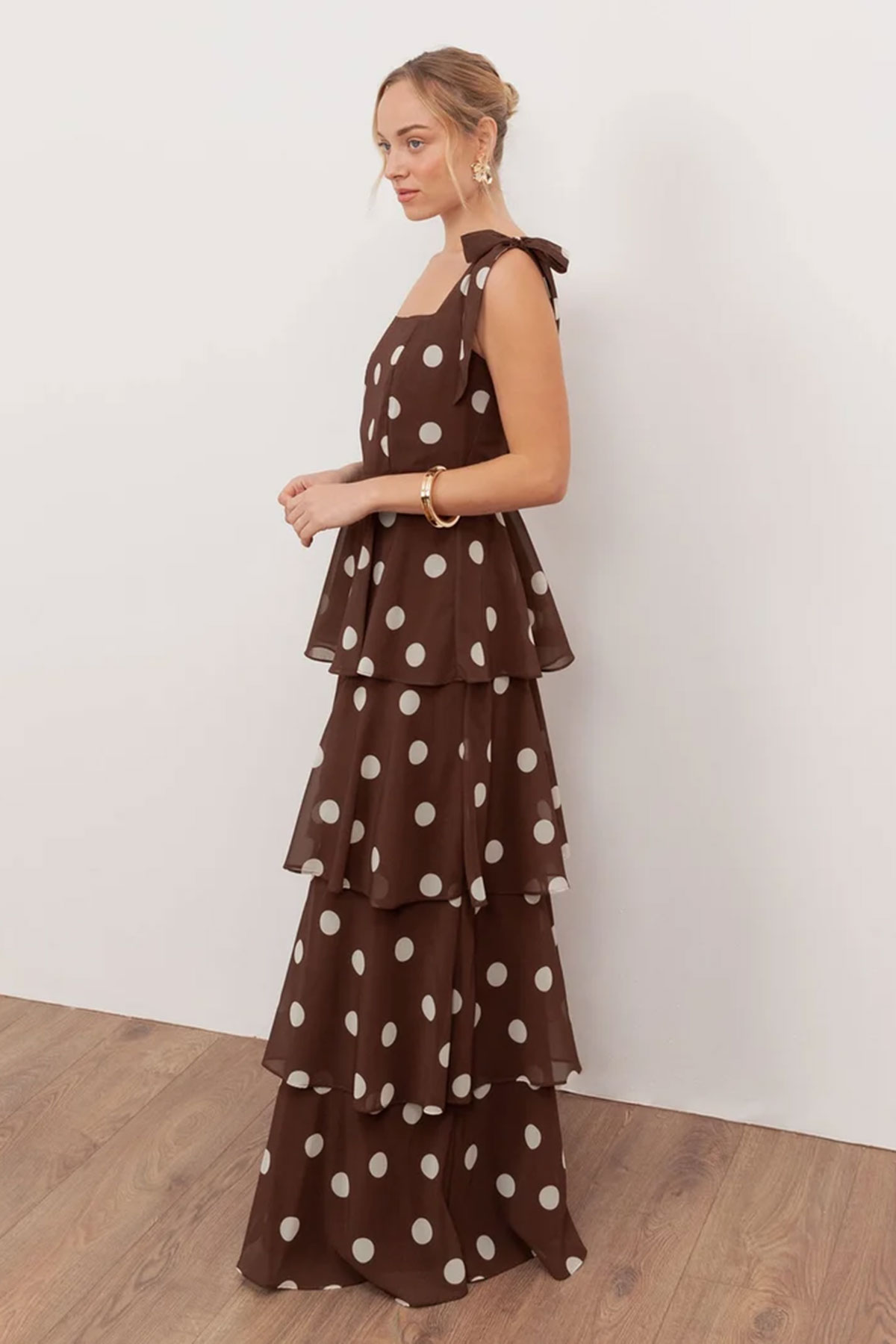 Brown polka dot tiered maxi dress with tie shoulder straps and ruffle layers