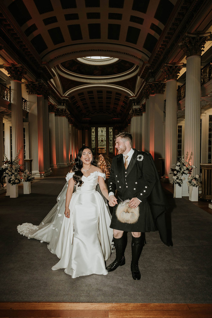 bride with 2 in 1 dress laughing with groom at signet library