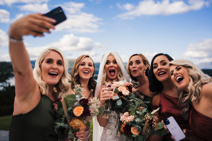 Bridesmaid takes selfie of bride and bridal party