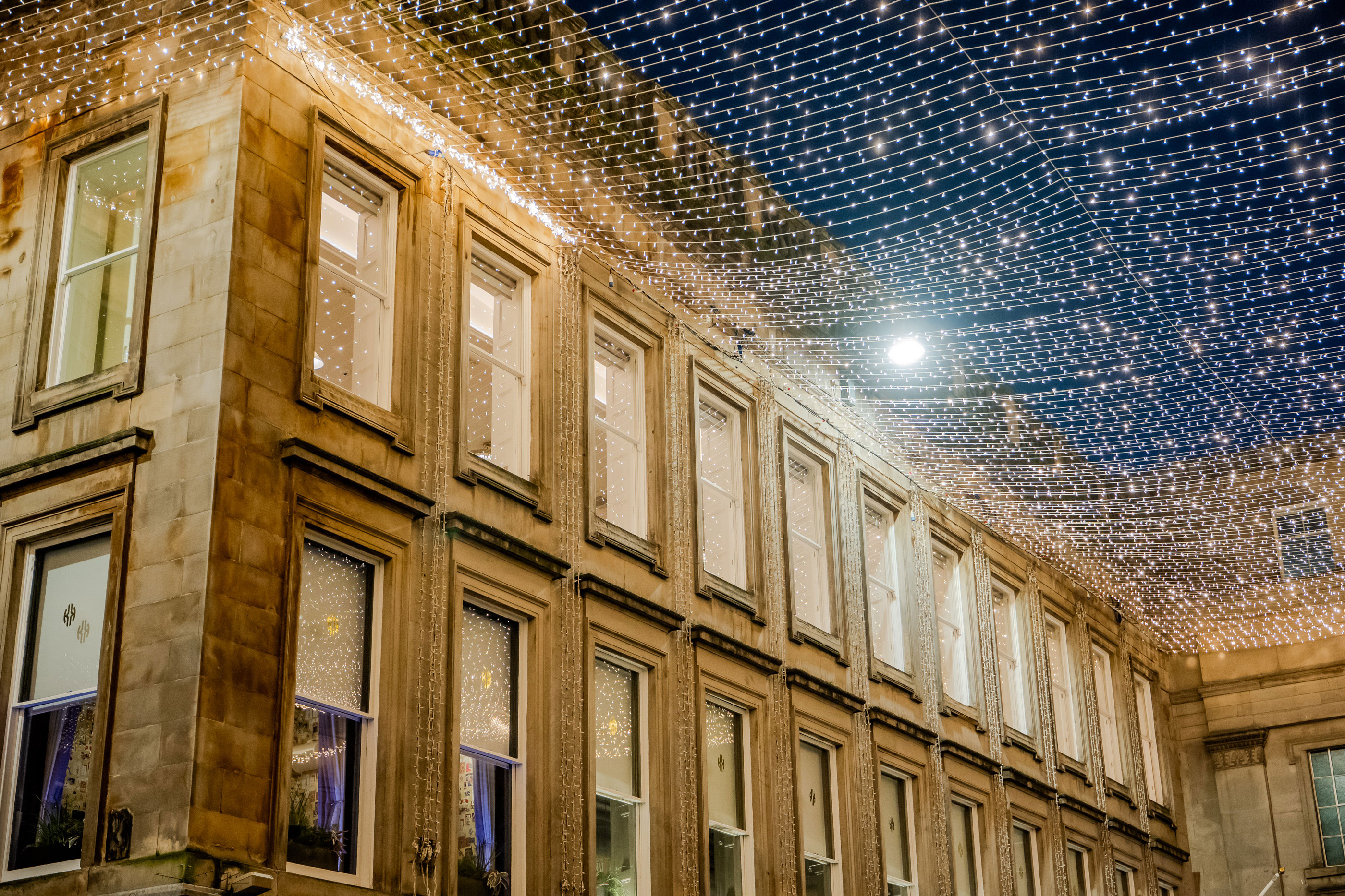 royal exchange square in glasgow with fairy lights and night sky