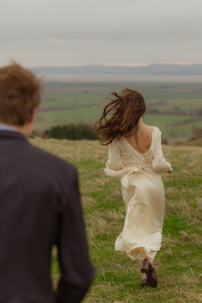 in focus picture of bride running away from the camera