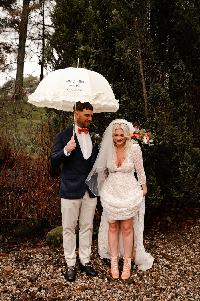 married couple standing in the rain after wedding at gretna green