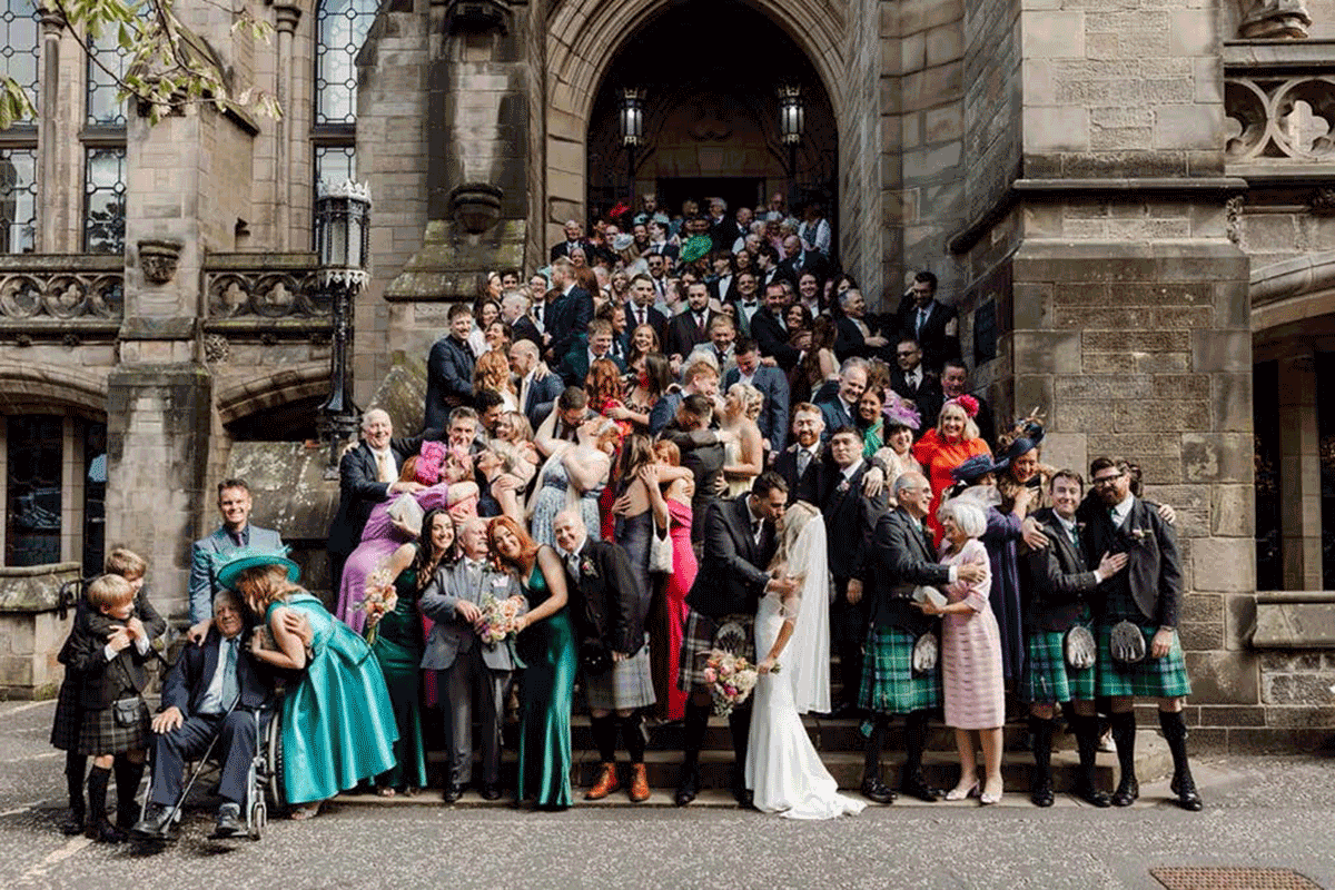 Big group wedding photo outside of the university of glasgow