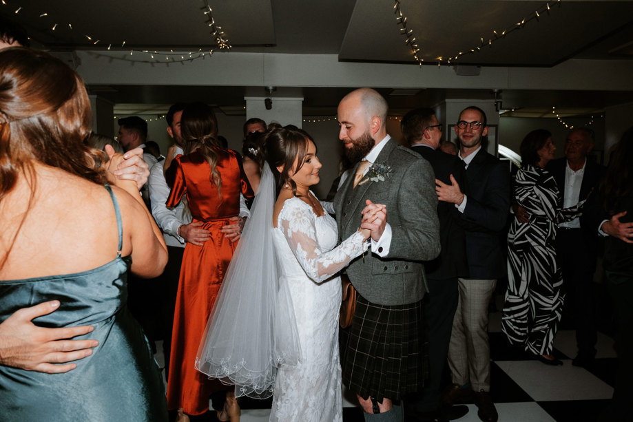 Bride and groom dancing together 