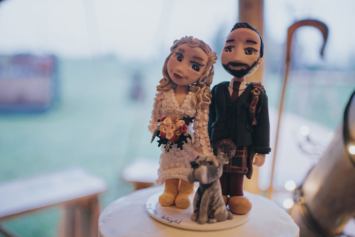 Cake topper depicting the couple and their dog