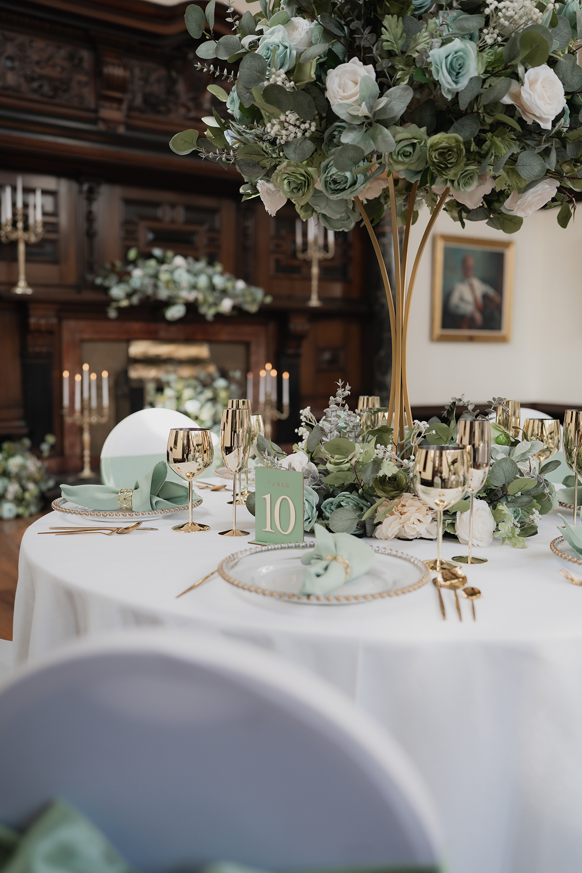 Wedding table styling at 1599 at the Royal College with green and white florals, gold glassware and elegant place settings