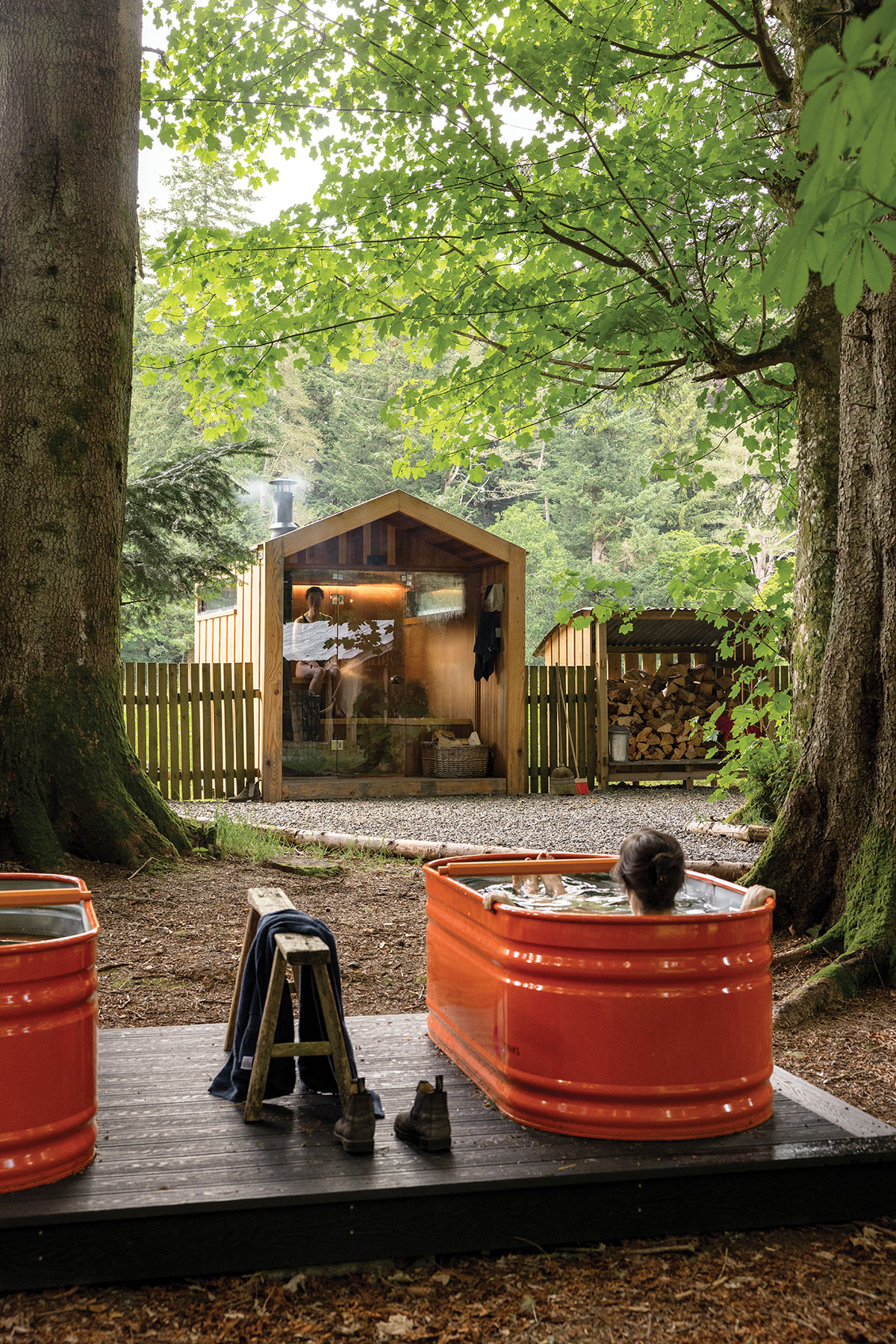 Guests relaxing in wood-fired cold plunge tubs beside the woodland sauna at Glen Dye Estate in Aberdeenshire