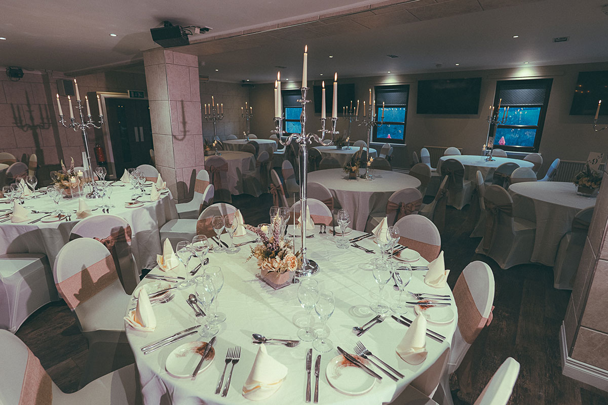 dinner set up with white chairs and pink fowers for a wedding ceremony at the river inn in glasgow