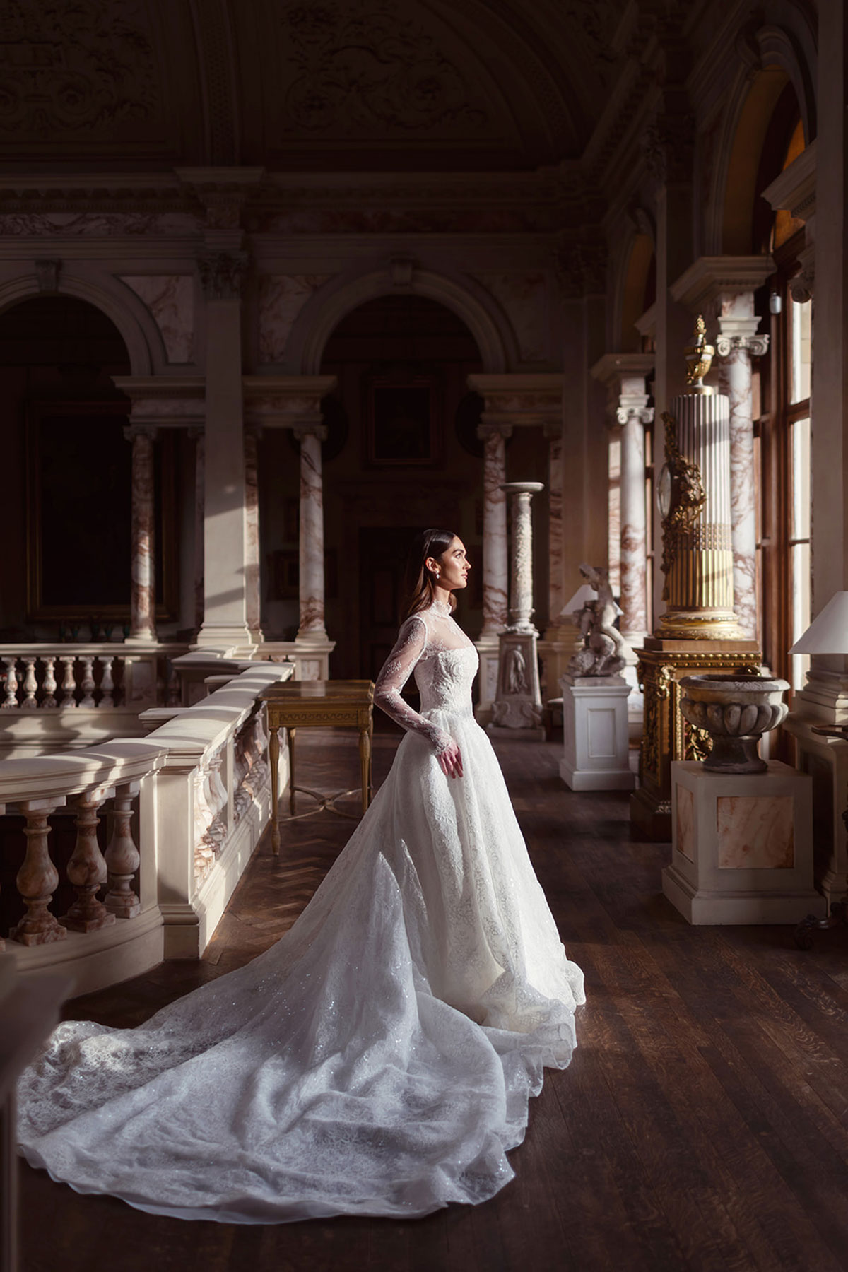 Bridal model in a lace wedding gown posed among the grand interiors of Gosford House.