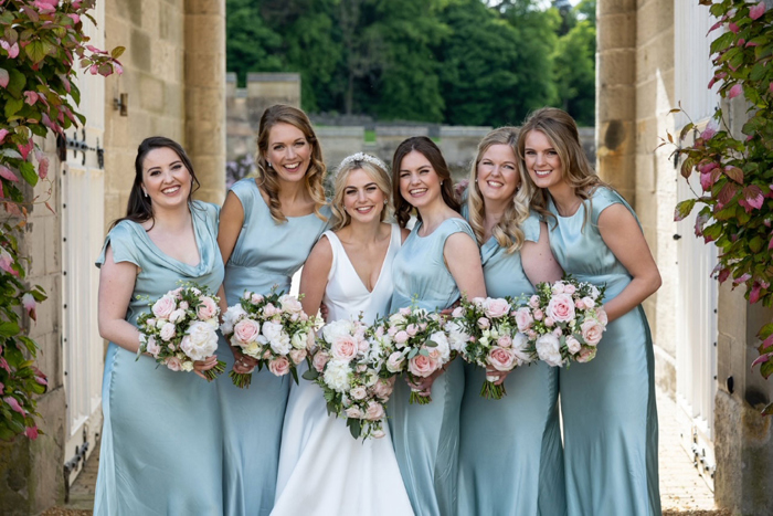 Bride and bridesmaids wearing blue dresses