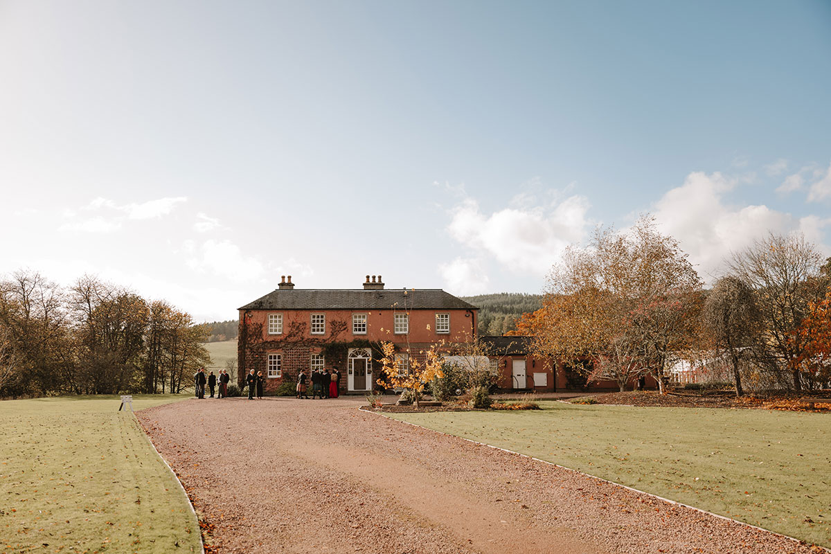 Front view of Ballogie House with guests arriving on a sunny autumn day.
