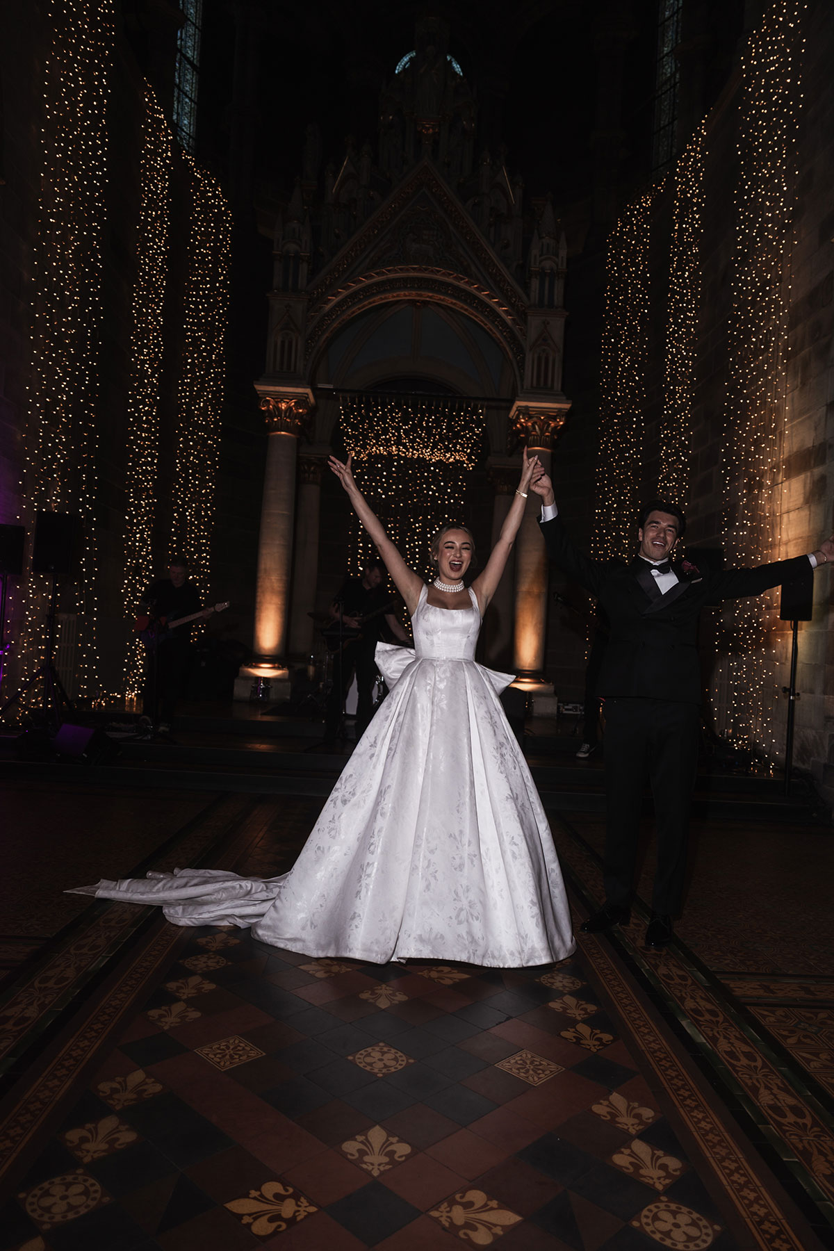 Newlyweds cheering and celebrating during Mansfield Traquair wedding reception evening