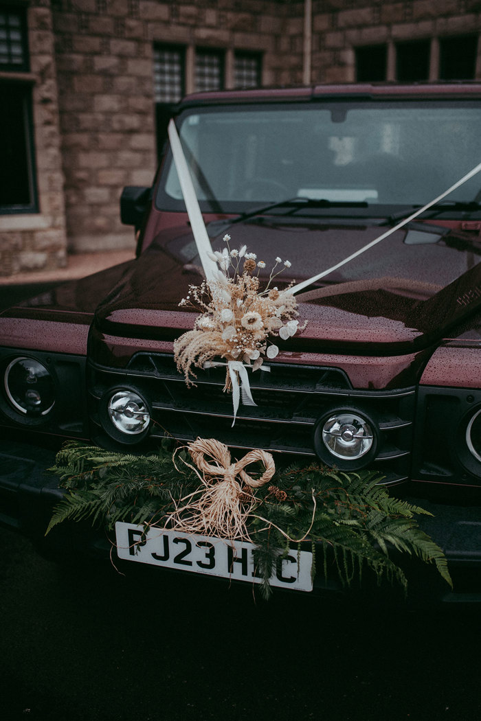 jeep-style car with flowers on top at mar lodge wedding