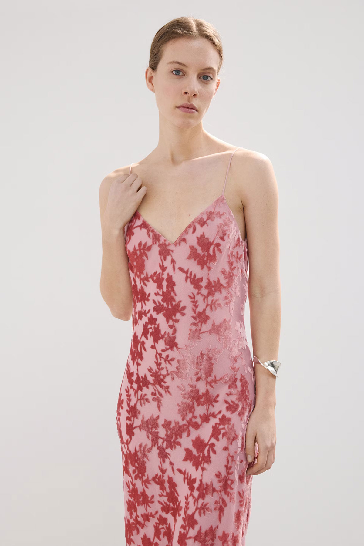 Pink devoré floral slip dress with delicate straps and semi-sheer finish styled in a minimal studio setting