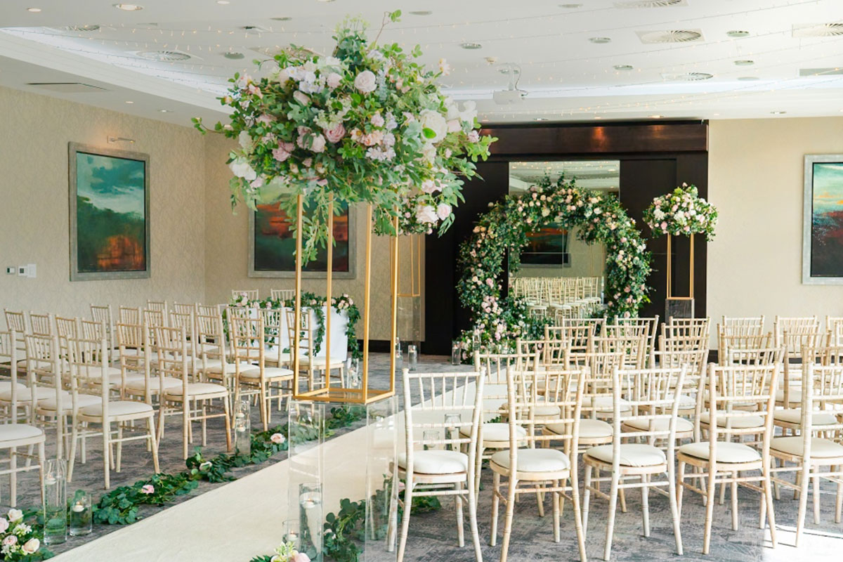 Garden Suite ceremony room at Norton House Hotel dressed with floral aisle décor and elegant wedding styling for a civil ceremony